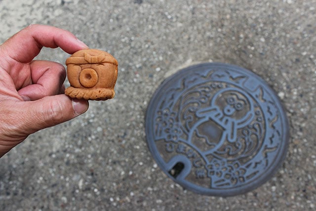 An octopus-shaped sweet manju bun, and an octopus manhole cover